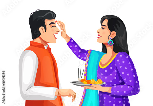Sister applying tilak on forehead to brother on Bhai Dooj or Raksha Bandhan