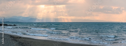 sunlight through the clouds of autumn sunset evening on the Mediterranean sea against the backdrop of mountains 4