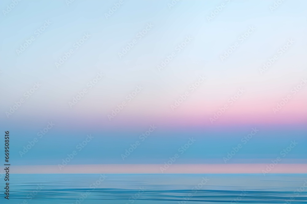 夕暮れの穏やか薄いブルーとピンクが混ざるパステルカラーの海と空の海岸線