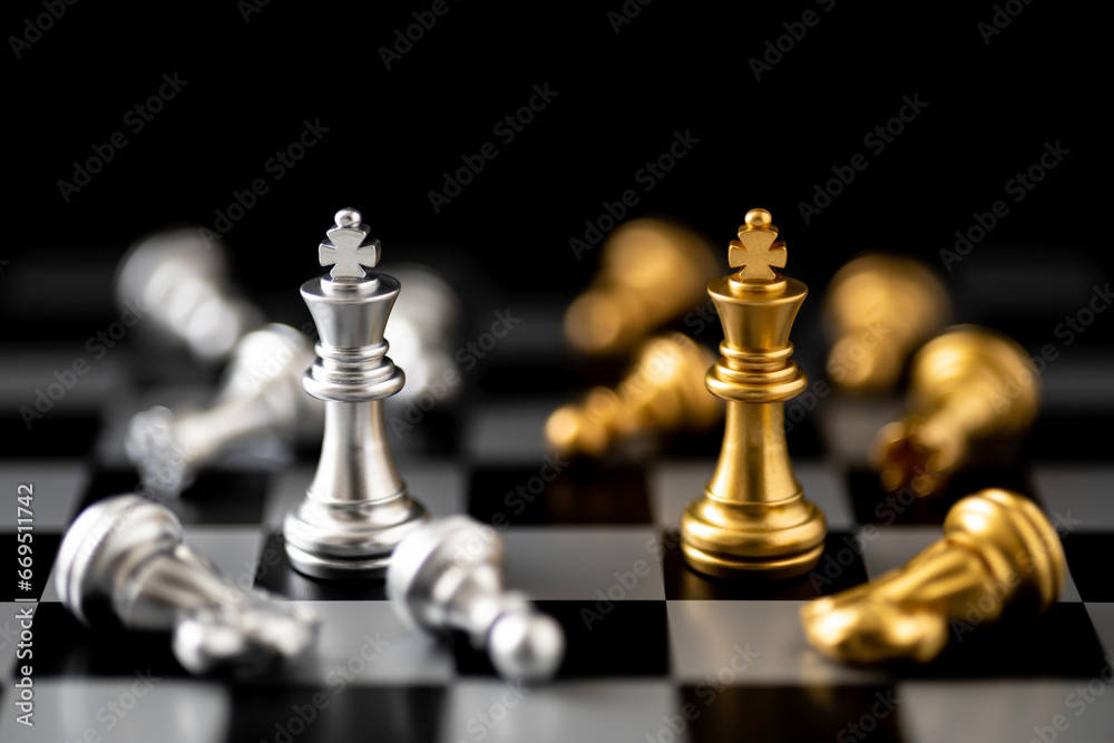 Golden and Silver King chess standing in front of other chess on chess board. Golden and Silver King chess standing in front of other chess on chess board.