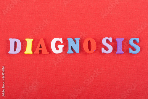 DIAGNOSIS word on red background composed from colorful abc alphabet block wooden letters, copy space for ad text. Learning english concept.