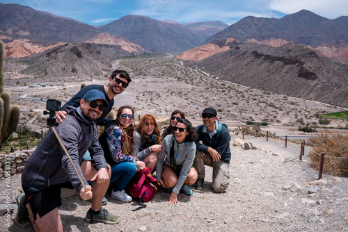 Grupo de amigos tomandose una selfie en los paisajes de Tilcara, Provincia de Jujuy, Argentina photo