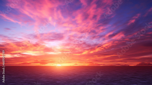 A stunning sunset, with the sky aflame in a spectrum of pinks, oranges, and purples The sun slowly dips below the horizon, casting a golden light over the landscape