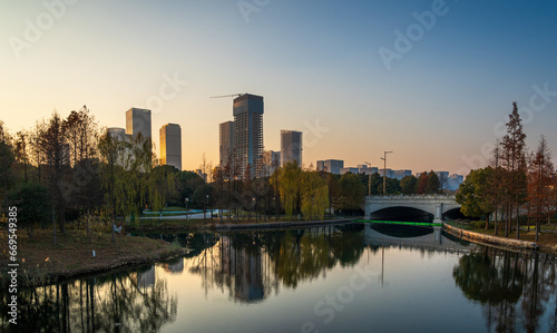 A modern city by the lake at sunset © evening_tao