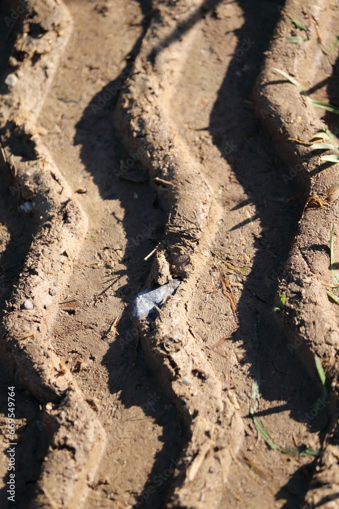 Closeup of tractor tracks in the dried mud Closeup of tractor tracks in the dried mud