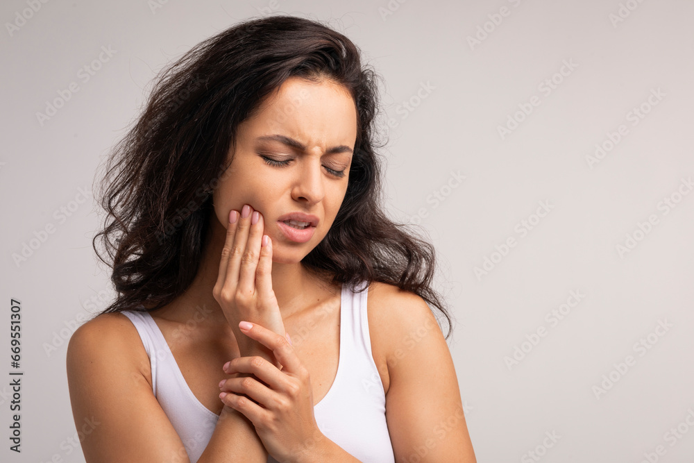 Upset millennial woman suffering from strong tooth pain Upset millennial woman suffering from strong tooth pain
