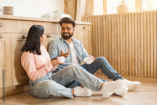 Картината върху платно Young Hindu couple chatting over coffee at home in kitchen