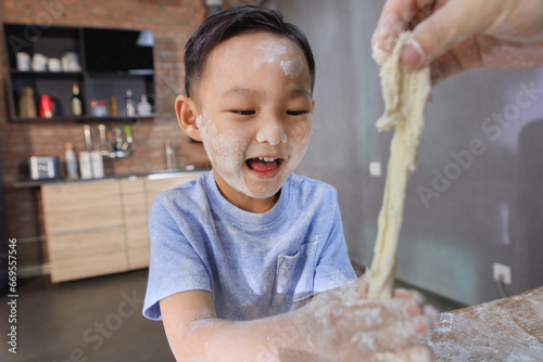 The little boy who mixed noodles photo