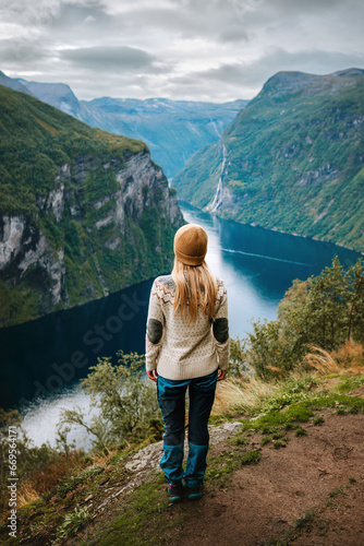 Woman tourist hiking in Norway alone sightseeing Geiranger fjord landscape adventure active lifestyle vacations sustainable tourism scandinavian tour © EVERST