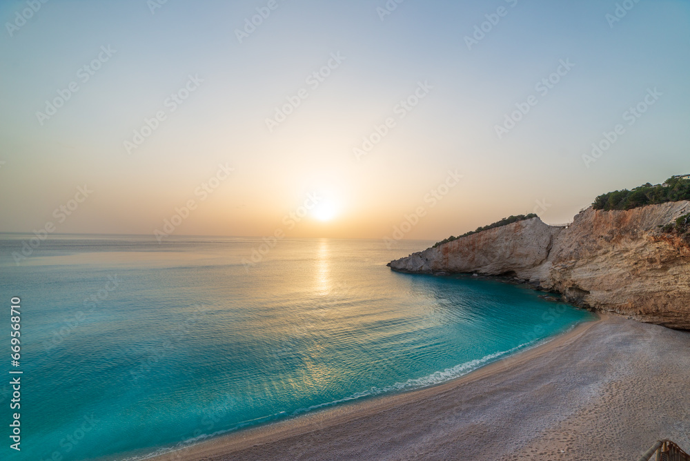 Beautiful beach and water bay in the greek spectacular coast line. Sunset gorgeous sky over blue water unique rocky cliffs. Greece summer top travel destination Lefkada island Beautiful beach and water bay in the greek spectacular coast line. Sunset gorgeous sky over blue water unique rocky cliffs. Greece summer top travel destination Lefkada island