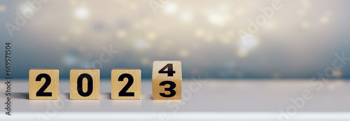 Wooden cubes on white table symbolizing the turn of the year (2023 / 2024)