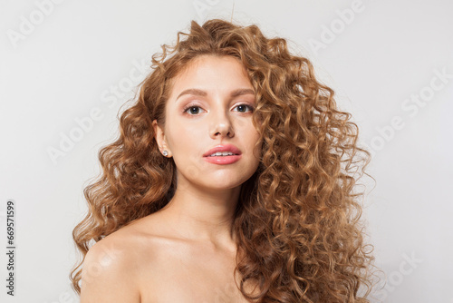 Lovely redhead woman with long healthy wavy red hairstyle. Natural beauty without retouching. Beautiful curly hair model