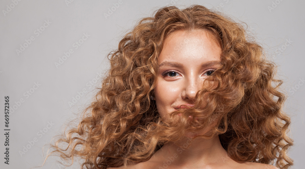Fototapeta premium Happy hair model. Beautiful woman with wavy hairstyle. Pretty young woman with curly hair