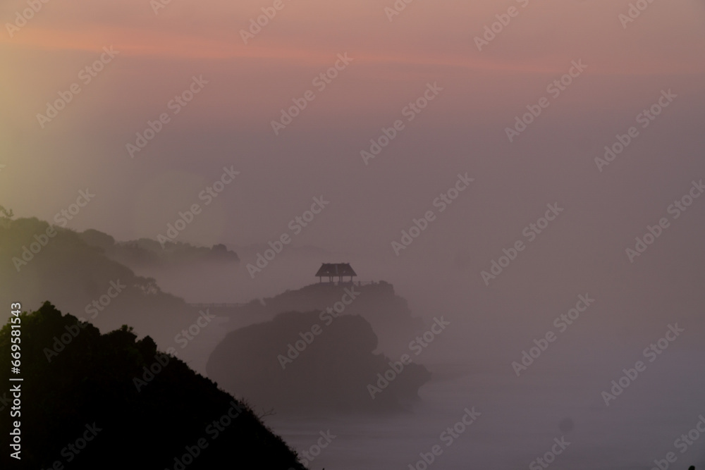 Foggy morning on the beach with sunrise sky - Kukup Beach, Wonosari, Gunung Kidul, Yogyakarta, Indonesia
