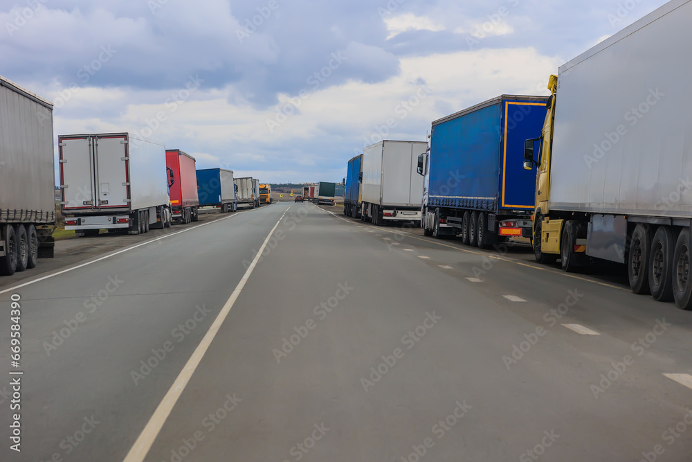 Many trucks parked on the side of road