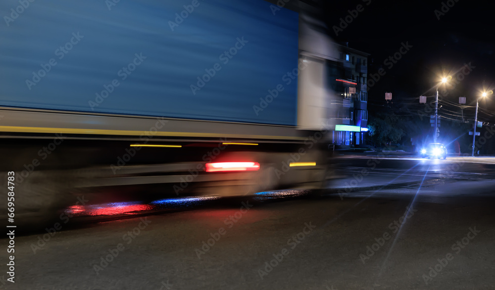 Truck Drives Along City Street at Night.