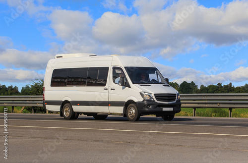 Minibus moves along a country road