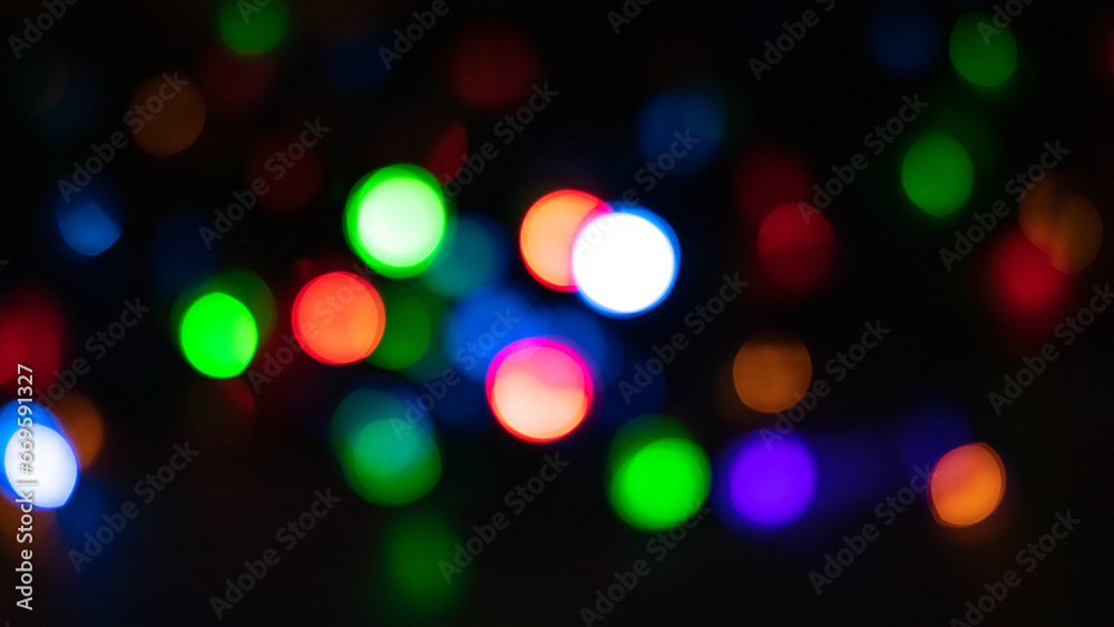 Festive Christmas and New Year background with bokeh, blurred lights on black background
