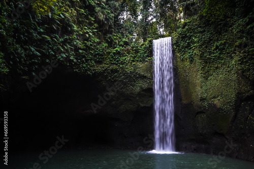 Beautiful Tibumana Waterfall with turquoise water in Gianyar, Bali, Indonesia. Waterfall with many beautiful plants and mosses. Fresh dan relaxing place. Bali Tourism and Tourist destination Concept photo