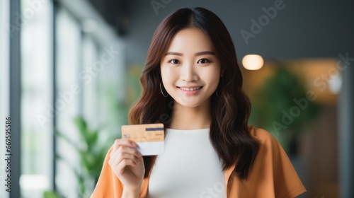 Asian female use credit card for pay online shopping
