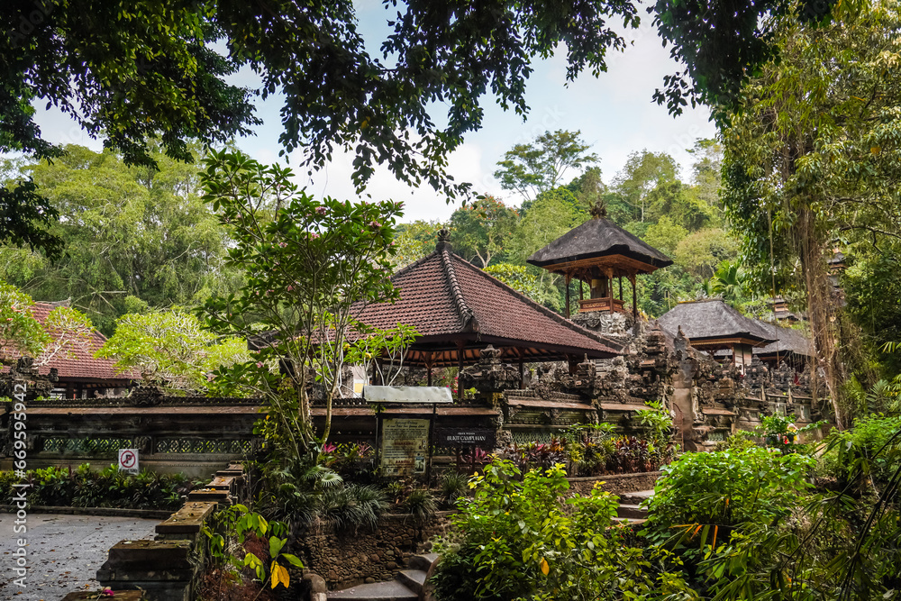 Balinese traditional temple building called pura in the middle of forest at Bukit Campuhan near the ridge walks. Concept for Bali Tourism, Indonesia tropical island tourist destination.