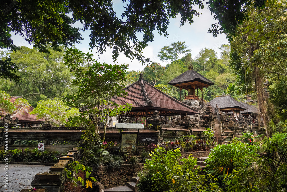 Balinese traditional temple building called pura in the middle of forest at Bukit Campuhan near the ridge walks. Concept for Bali Tourism, Indonesia tropical island tourist destination. Balinese traditional temple building called pura in the middle of forest at Bukit Campuhan near the ridge walks. Concept for Bali Tourism, Indonesia tropical island tourist destination.