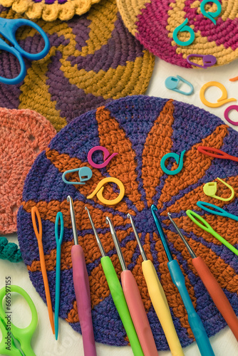 Bright colorful crochet coasters and crochet kit with crochet hooks, markers, needles and scissors.