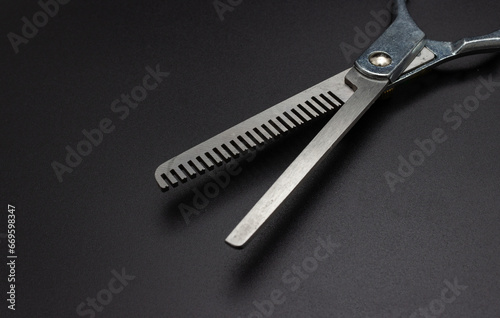 Professional hairdressers equipment. Hairdresser tools. Hairdresser salon concept. Haircut accessories. Hairdressing scissors on black background.