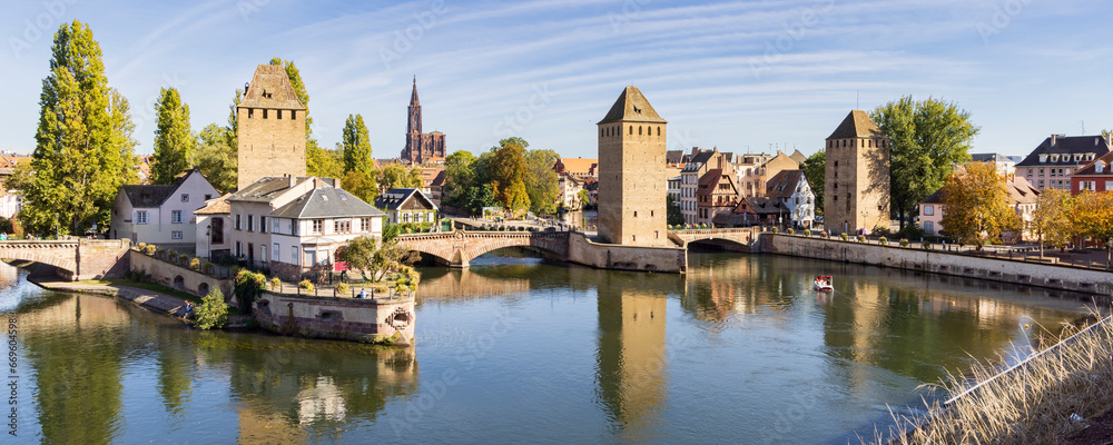 Barrage Vauban and tourist cruise ship scenic view of Strasbourg in Elsace region along the Rhine river in France