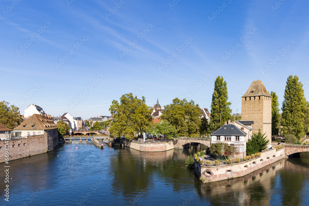 Barrage Vauban and tourist cruise ship scenic view of Strasbourg in Elsace region along the Rhine river in France