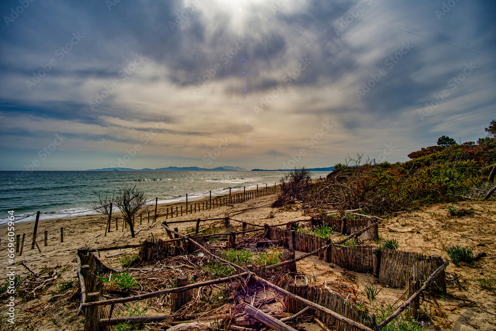 View of the Riotorto beach in the Carbonifera area, in the foreground you can see the fences for strengthening the dunes Riotorto PiombinoTuscany Italy View of the Riotorto beach in the Carbonifera area, in the foreground you can see the fences for strengthening the dunes Riotorto PiombinoTuscany Italy