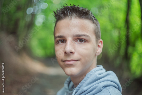 Cute little curious boy in green nature waiting for magic. Inquisitive childhood.
