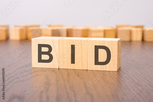 bid text on wooden blocks. wooden background. foreground