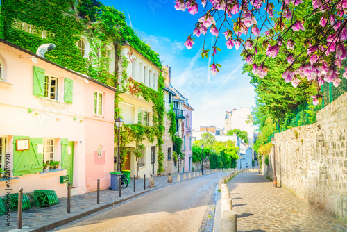 View of cosy street in quarter Montmartre in Paris, France. Cozy cityscape of Paris at summer. Architecture and landmarks of Paris. © neirfy