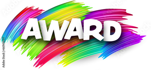 Award paper word sign with colorful spectrum paint brush strokes over white.