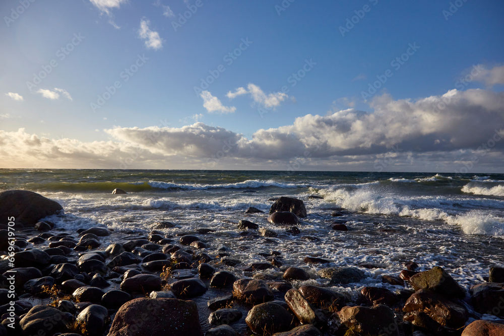 Windy day on the seashore with waves on the sea and cloudy sky above, selective focus Windy day on the seashore with waves on the sea and cloudy sky above, selective focus