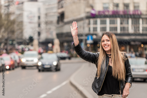 Young woman trying to catch a taxi
