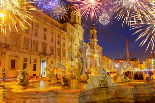 view of Piazza Navona and fountains in Rome at night with fireworks, Italy