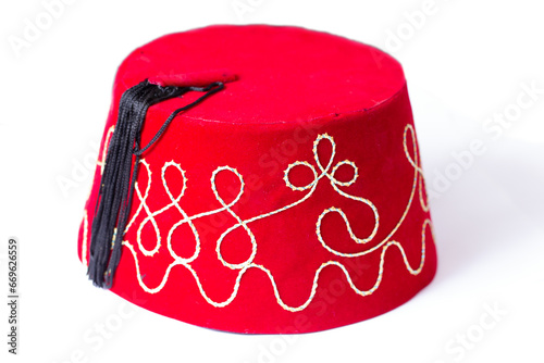 Red fez hat or tarbush hat with festive decoration isolated on the white background