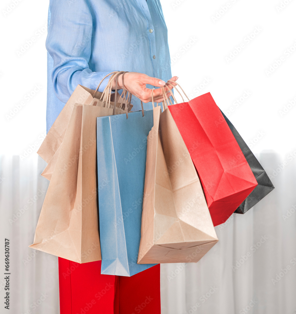 The girl holds a lot of craft bags in her hand. Shopping concept