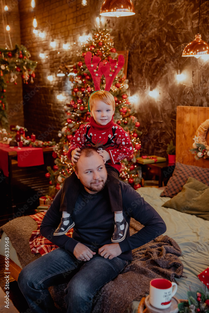 Happy father with son on his shoulders on new year or christmas Happy father with son on his shoulders on new year or christmas