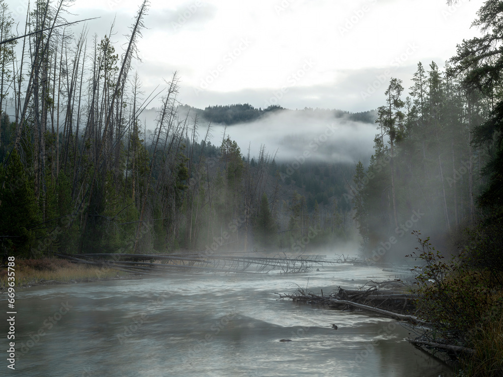 Idaho mountain stream with fog lifting to the high mountains Idaho mountain stream with fog lifting to the high mountains