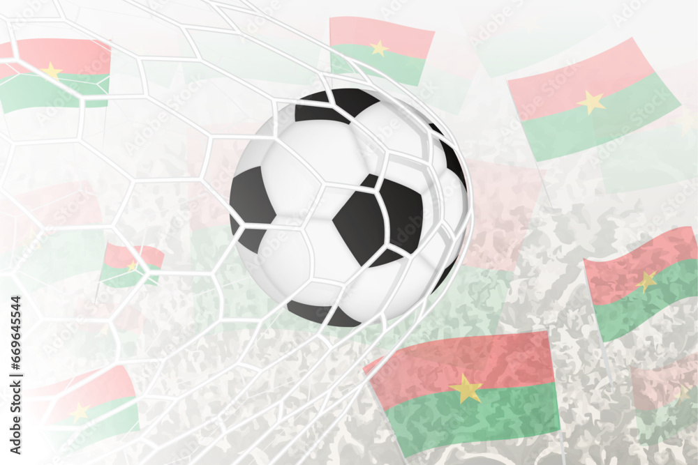 National Football team of Burkina Faso scored goal. Ball in goal net, while football supporters are waving the Burkina Faso flag in the background. National Football team of Burkina Faso scored goal. Ball in goal net, while football supporters are waving the Burkina Faso flag in the background.