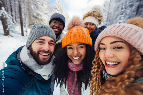 Multiethnic friends having fun taking and selfie together outdoors in winter In forest