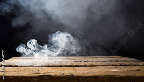 smoke on a wooden table in front of a black background high quality photo