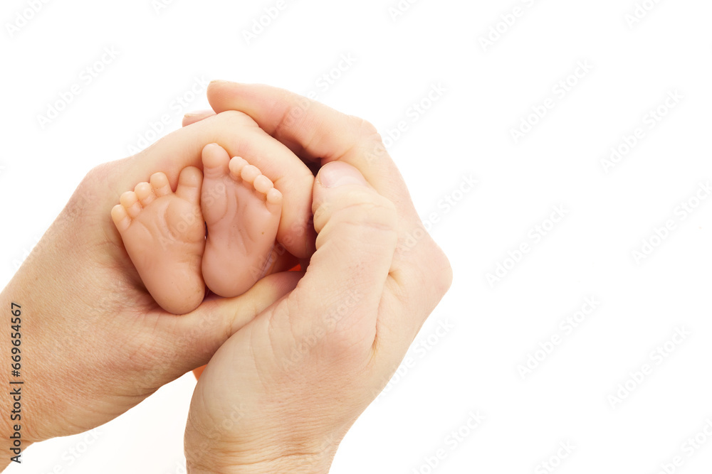 World Prematurity Day on 17th November. Woman hand with a baby feet . Motherhood and care. World Prematurity Day on 17th November. Woman hand with a baby feet . Motherhood and care.