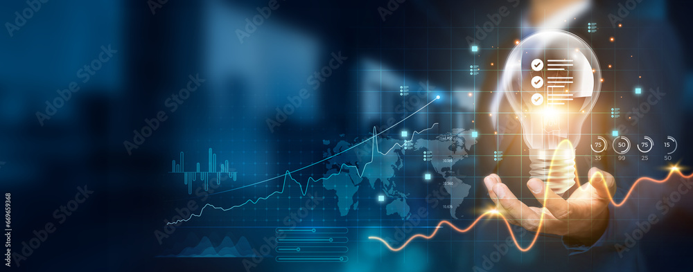 Businessman holding creative light bulb with growth graph and standard ...