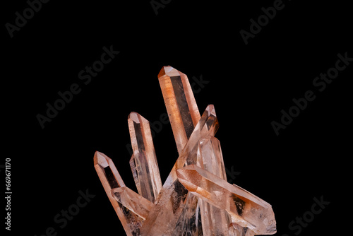 Hematoid Quartz crystal cluster macro detail black isolated background. close-up rough raw unpolished semi-precious gemstone. photo