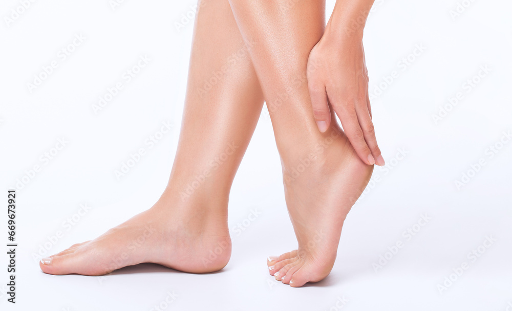 Beautiful, healthy and well-groomed feet of a young woman on a white background.