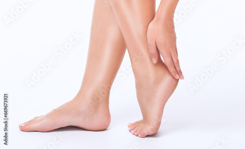 Beautiful, healthy and well-groomed feet of a young woman on a white background. © Dimid